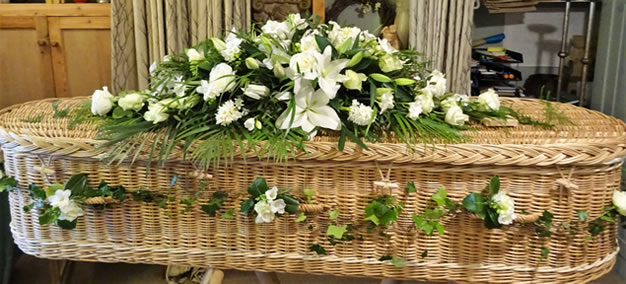Classic white coffin spray teamed with dark green foliage.