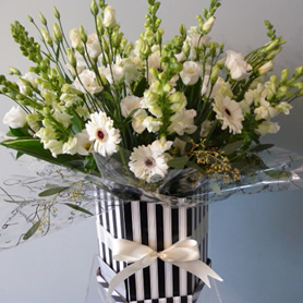 Large hat box of classic all white seasonal flowers.