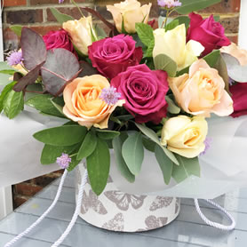 Our vintage hatbox of 12  large headed roses with foliage.