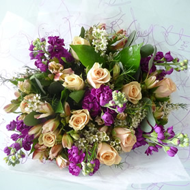 Hand tied bouquet containing best available seasonal flowers in eco- packaging.