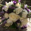 Bridal bouquet of purple eustoma, cream roses and lilac scented freesia.