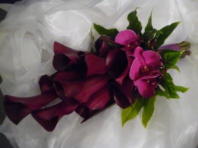 Contemporary Over-arm bouquet of black calla lilies and deep,  hot pink  phalaenopsis orchids