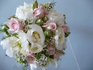 Beautiful wedding bouquet of lightly scented cream peonies, pale pink ‘Sweet Avalanche’ roses, white wax flowers and herbs.