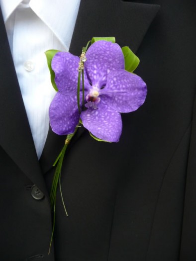 Buttonhole of a blue Vanda orchid with diamante detail.