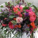 Large ‘Garden’ style wedding bouquet of scented coral peonies, pale pink ‘Sweet Avalanche’ roses, mixed with pops of bright orange spray roses and violet clematis and eucalyptus foliage.