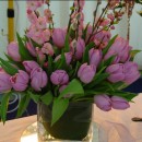 Cube vase of tulips and prunus