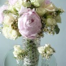 Vintage themed table flowers of peonies, roses and wax flowers