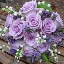 Wedding bouquet of lilac ‘Ocean Song’ roses teamed with scented lily of the valley and lavender.