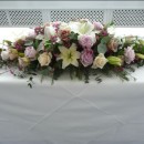 Vintage style top table arrangement of soft lilac and vintage champagne coloured roses