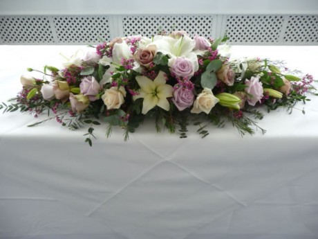 Vintage style top table arrangement of soft lilac and vintage champagne coloured roses