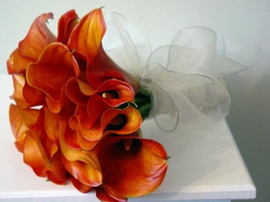 Mango calla lily bouquet, stems wrapped in white organza