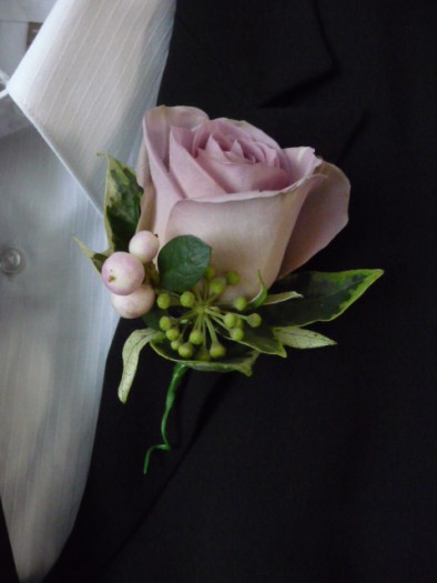 Vintage rose buttonhole.